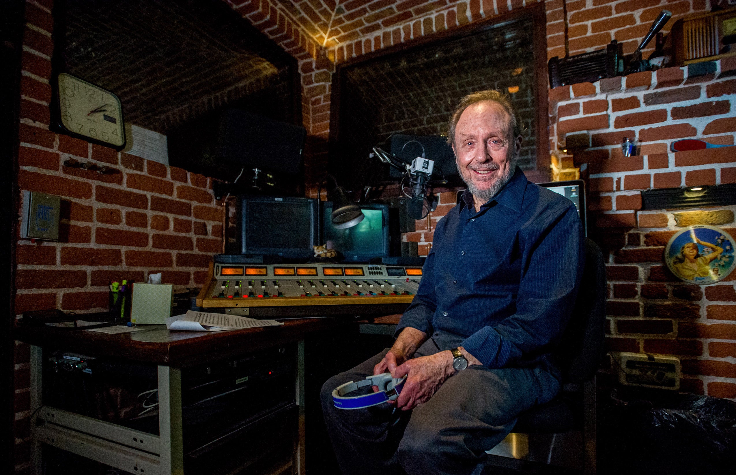 Portrait of a man sitting on a chair in a radio studio
