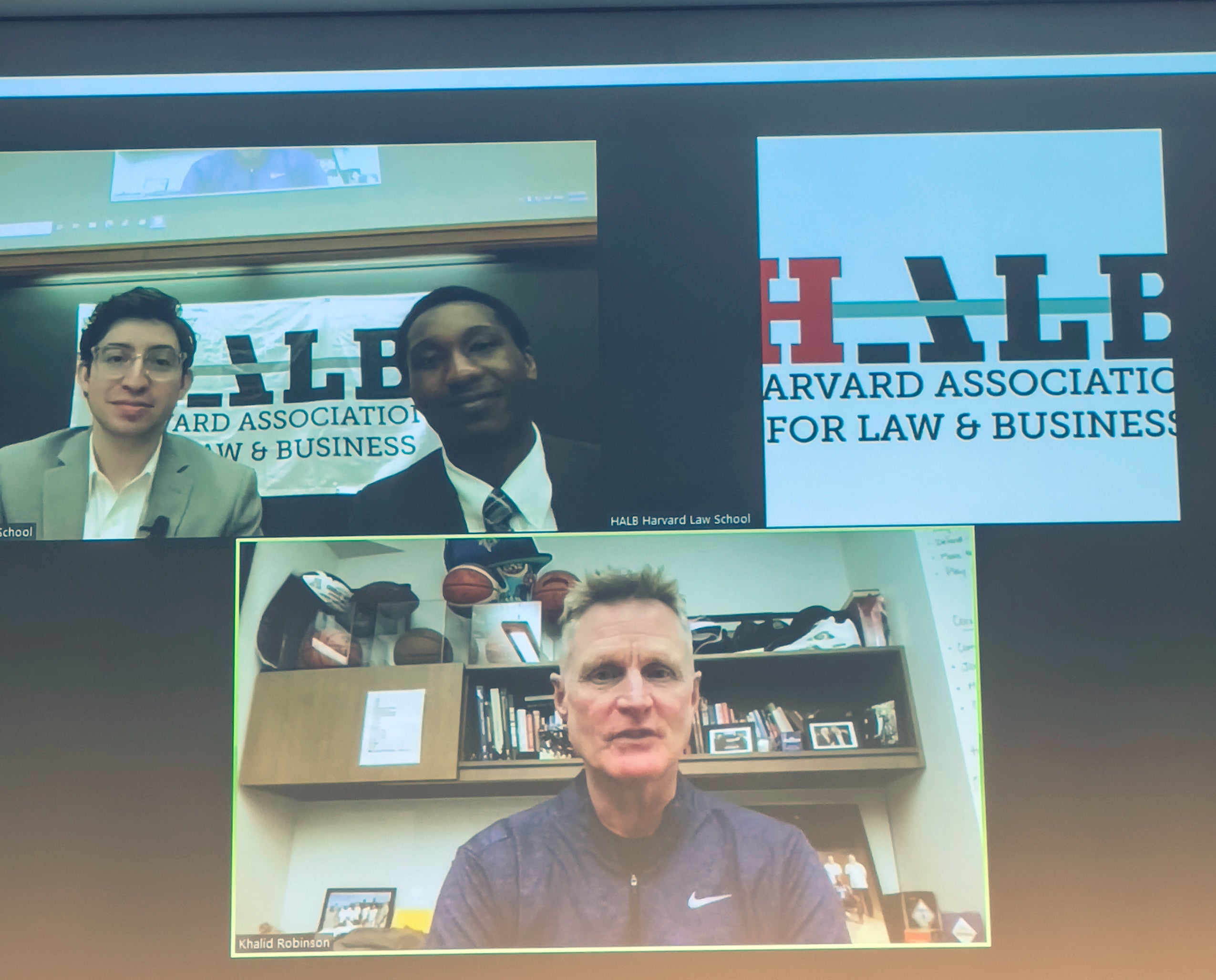 A screen shot of a man and two students at an online event sponsored by the Harvard Association for Law and Business