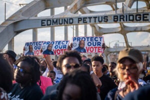 Voting rights activists march across the Edmund Pettus Bridge in Selma, Alabama in March 2022.