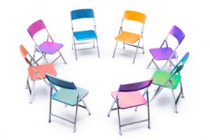 Circle of chairs of different colors.